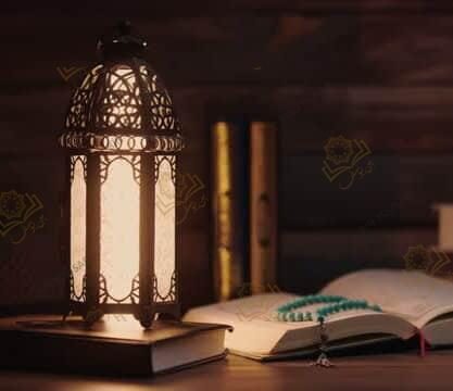 Islamic concept - The Holy Al Quran with written Arabic calligraphy meaning of Al Quran and a beautiful Arabian lamp, Arabic word translation: The Holy Al Quran (holy book of Muslim)